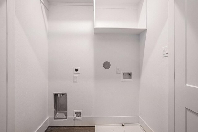 clothes washing area with hookup for an electric dryer, hookup for a washing machine, gas dryer hookup, baseboards, and wood finished floors