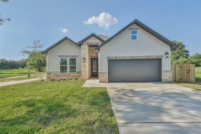 620 Lily St, Waller, TX 77484 - view of front of house with a front yard, an attached garage, stone siding, concrete driveway, and stucco siding