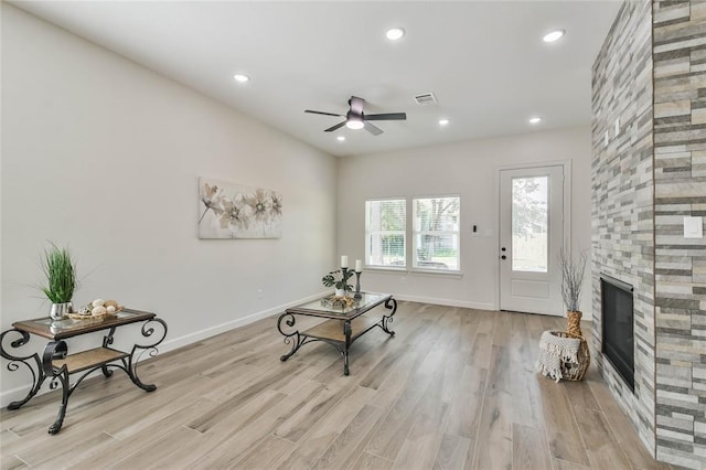 620 Lily St, Waller, TX 77484 - sitting room with baseboards, a stone fireplace, light wood-type flooring, recessed lighting, and a ceiling fan