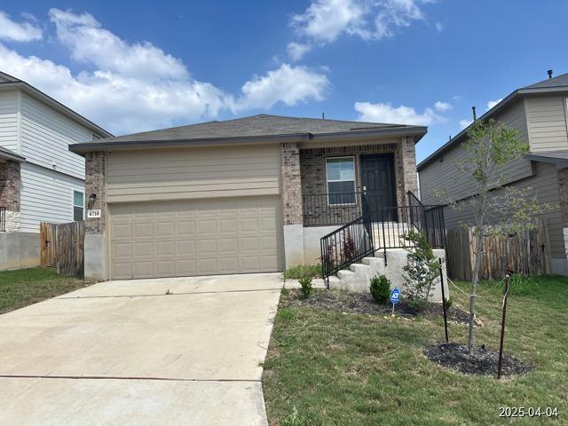 6710 Greensleeves, San Antonio, TX 78252 - view of front of property featuring a front yard, a garage, fence, brick siding, and driveway