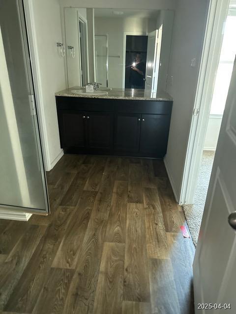 6710 Greensleeves, San Antonio, TX 78252 - bathroom with baseboards, vanity, and wood finished floors