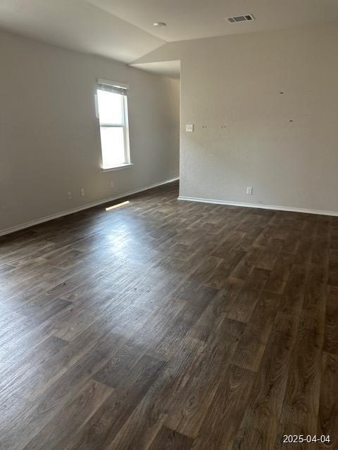 6710 Greensleeves, San Antonio, TX 78252 - spare room with dark wood-style floors, baseboards, visible vents, and lofted ceiling