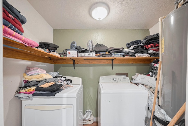 9034 Talton St, Houston, TX 77078 - clothes washing area featuring washing machine and dryer, a textured ceiling, and laundry area