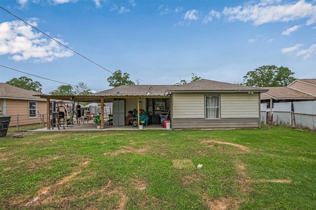 9034 Talton St, Houston, TX 77078 - back of property with a patio area, fence, and a lawn