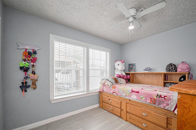 9034 Talton St, Houston, TX 77078 - bedroom with a textured ceiling, ceiling fan, and baseboards