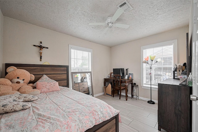 9034 Talton St, Houston, TX 77078 - bedroom featuring visible vents, multiple windows, baseboards, and a textured ceiling