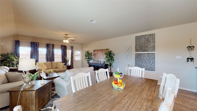 dining area with wood finished floors, ceiling fan, baseboards, and visible vents