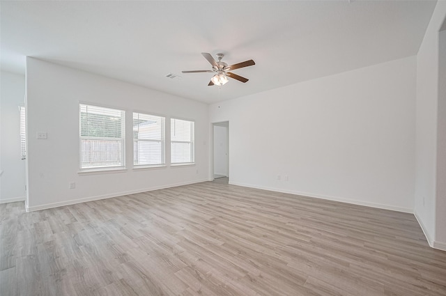 22607 Rising Rosehill Ln, Tomball, TX 77377 - spare room with a ceiling fan, light wood finished floors, and baseboards