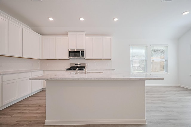 22607 Rising Rosehill Ln, Tomball, TX 77377 - kitchen featuring stainless steel appliances, a sink, recessed lighting, light wood-style floors, and decorative backsplash