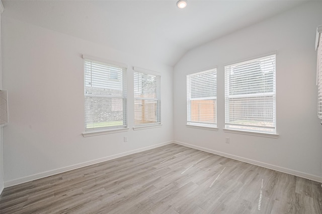 22607 Rising Rosehill Ln, Tomball, TX 77377 - spare room with light wood-style flooring, lofted ceiling, baseboards, and recessed lighting