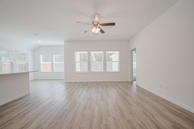 22607 Rising Rosehill Ln, Tomball, TX 77377 - unfurnished living room featuring a ceiling fan, healthy amount of natural light, and light wood finished floors