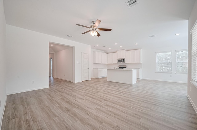 22607 Rising Rosehill Ln, Tomball, TX 77377 - unfurnished living room with a ceiling fan, baseboards, light wood finished floors, and recessed lighting