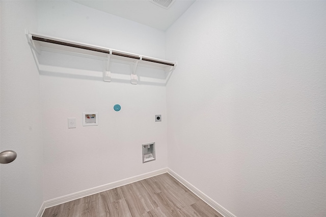 22607 Rising Rosehill Ln, Tomball, TX 77377 - laundry area featuring electric dryer hookup, hookup for a washing machine, light wood-style flooring, and baseboards