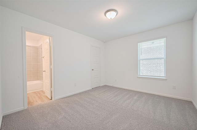 22607 Rising Rosehill Ln, Tomball, TX 77377 - unfurnished bedroom with carpet floors, baseboards, and ensuite bathroom