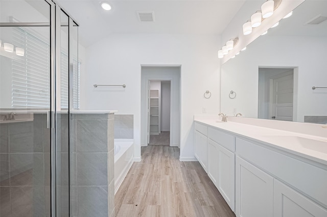 22607 Rising Rosehill Ln, Tomball, TX 77377 - bathroom featuring wood finished floors, a shower stall, a bath, and vaulted ceiling