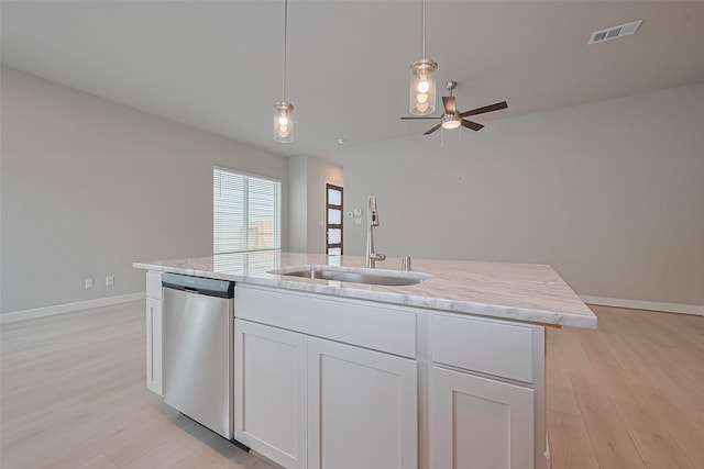 8915 Grovner Pl, Houston, TX 77055 - kitchen with stainless steel dishwasher, a sink, light wood-style flooring, and baseboards