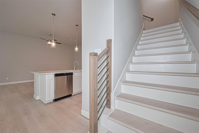 8915 Grovner Pl, Houston, TX 77055 - staircase with wood finished floors, ceiling fan, and baseboards