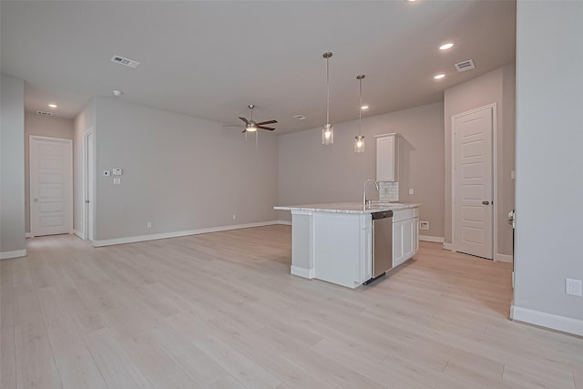 8915 Grovner Pl, Houston, TX 77055 - kitchen with a ceiling fan, light countertops, light wood-type flooring, white cabinets, and recessed lighting