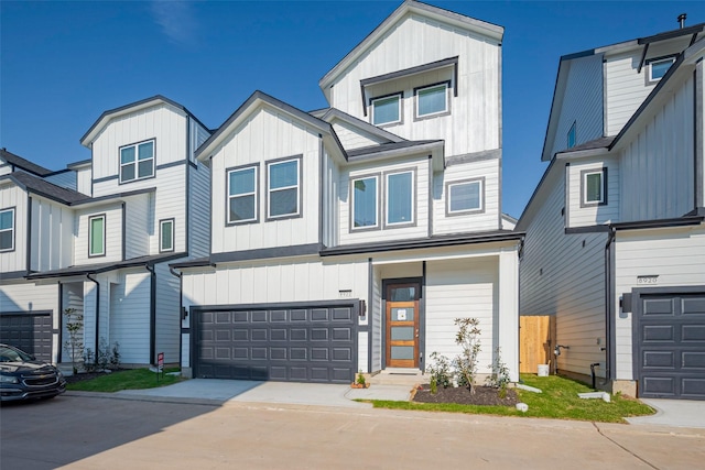 multi unit property with a garage, board and batten siding, and concrete driveway
