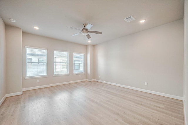 empty room featuring baseboards, recessed lighting, light wood-style flooring, a ceiling fan, and visible vents