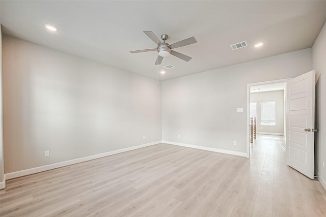 unfurnished room with light wood-style flooring, visible vents, ceiling fan, and baseboards