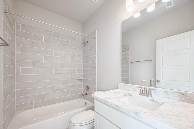 bathroom featuring visible vents, toilet, vanity, and shower / bathtub combination