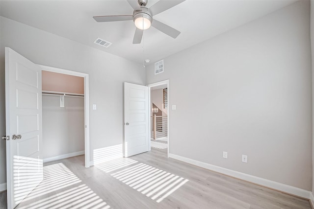 unfurnished bedroom featuring light wood-style floors, baseboards, and visible vents