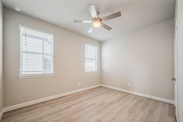 empty room featuring light wood-style floors, baseboards, and a ceiling fan