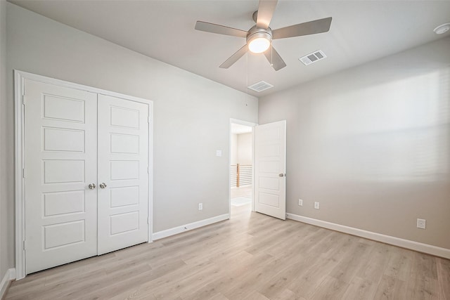 unfurnished bedroom featuring light wood-style floors, visible vents, and baseboards
