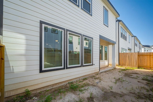 view of side of property featuring fence
