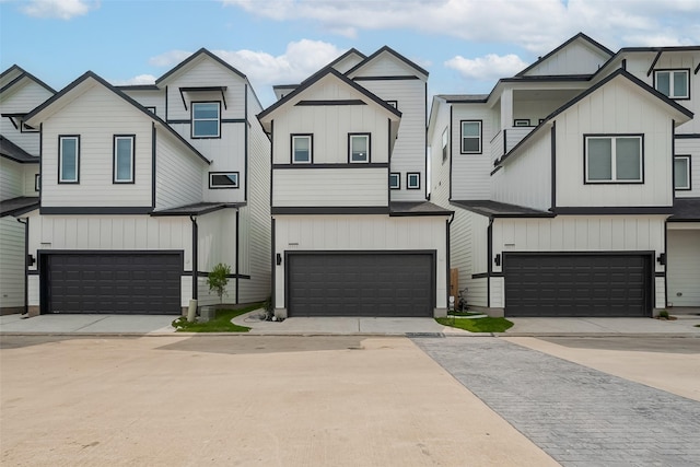 1611 Regents Gate Ct, Houston, TX 77055 - view of front of home featuring a garage, board and batten siding, and driveway