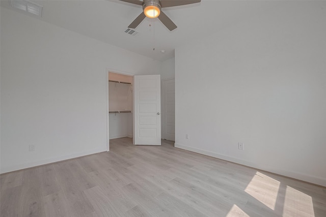 1611 Regents Gate Ct, Houston, TX 77055 - unfurnished bedroom featuring light wood-style flooring, baseboards, a spacious closet, vaulted ceiling, and a closet
