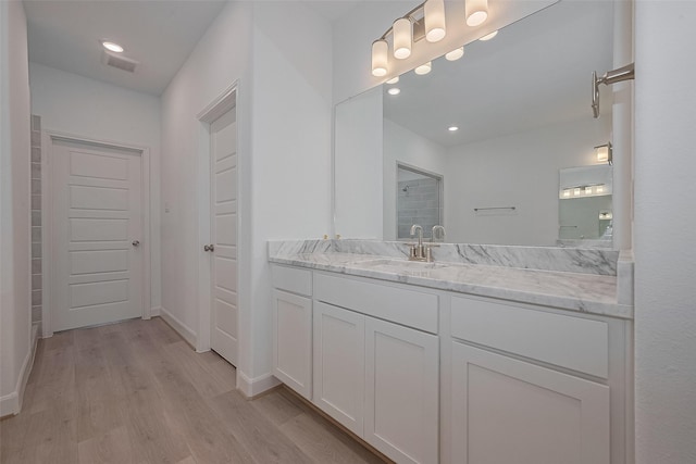1611 Regents Gate Ct, Houston, TX 77055 - bathroom featuring wood finished floors, vanity, baseboards, recessed lighting, and a shower