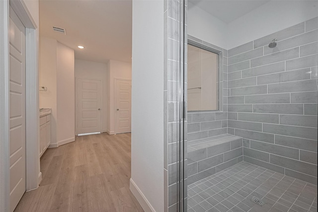 1611 Regents Gate Ct, Houston, TX 77055 - full bath with a tile shower, wood finished floors, vanity, recessed lighting, and baseboards