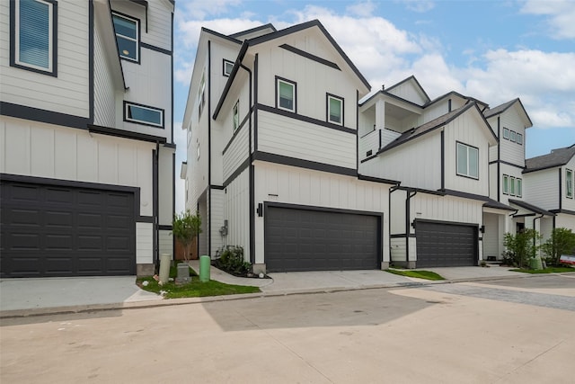 1611 Regents Gate Ct, Houston, TX 77055 - view of property featuring a garage, board and batten siding, driveway, and a balcony