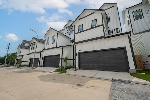1611 Regents Gate Ct, Houston, TX 77055 - view of front facade with an attached garage, board and batten siding, and concrete driveway