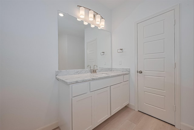 8928 Covenant Pl, Houston, TX 77055 - bathroom with vanity, baseboards, and wood finished floors