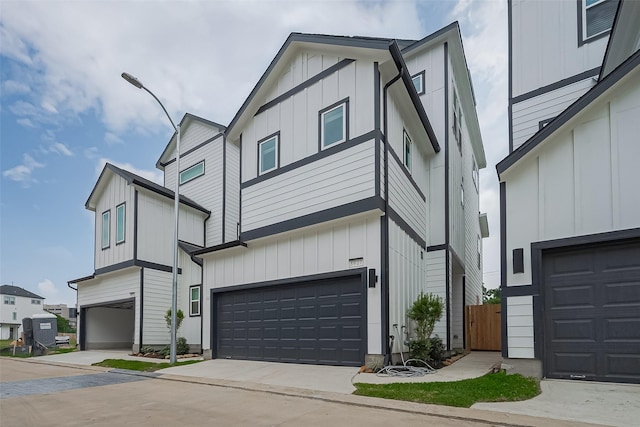 8928 Covenant Pl, Houston, TX 77055 - view of front facade featuring board and batten siding, a garage, and concrete driveway