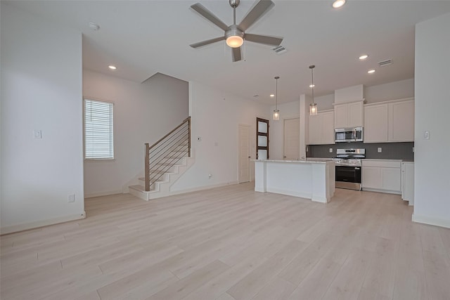 8928 Covenant Pl, Houston, TX 77055 - kitchen with appliances with stainless steel finishes, decorative backsplash, open floor plan, a ceiling fan, and recessed lighting