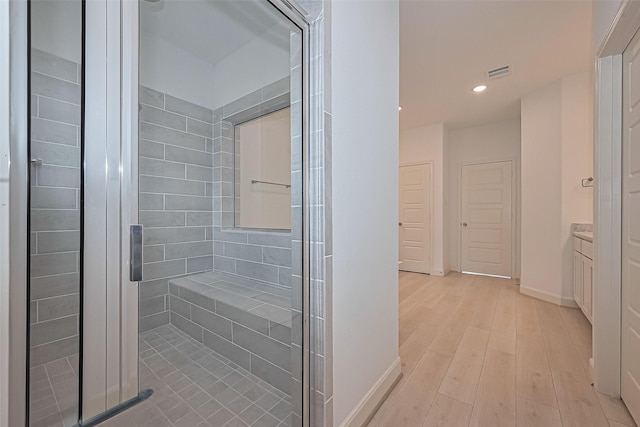 8928 Covenant Pl, Houston, TX 77055 - bathroom with vanity, baseboards, a shower stall, recessed lighting, and wood finished floors