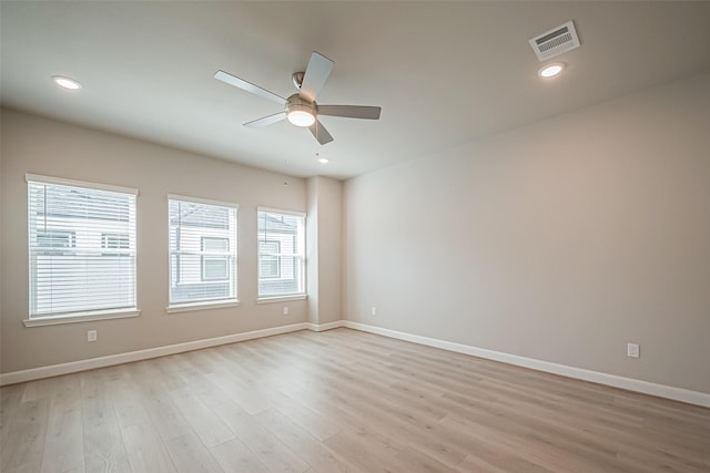spare room with visible vents, baseboards, light wood-type flooring, a ceiling fan, and recessed lighting