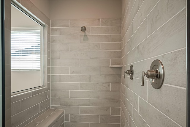 bathroom with a tile shower