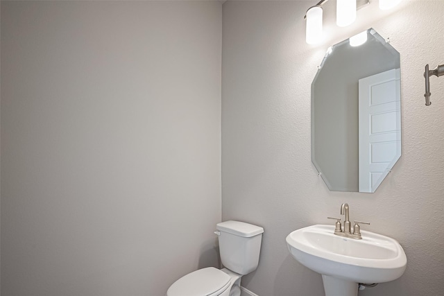bathroom featuring a sink and toilet