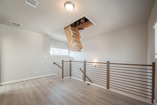 additional living space featuring visible vents, baseboards, and wood finished floors