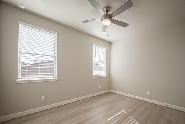 empty room with light wood-type flooring, ceiling fan, and baseboards