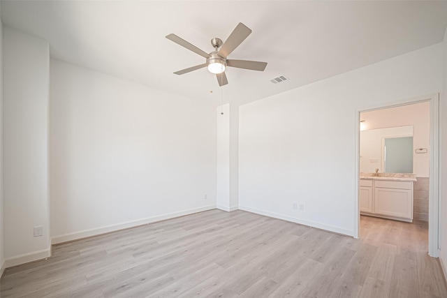 unfurnished bedroom with visible vents, light wood-type flooring, baseboards, and ensuite bathroom