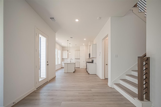 entryway featuring visible vents, stairway, recessed lighting, and light wood finished floors