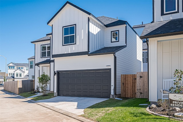 view of front of home with concrete driveway, board and batten siding, fence, and an attached garage