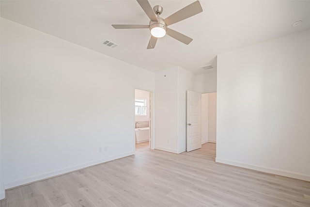 empty room featuring visible vents, ceiling fan, and light wood-type flooring