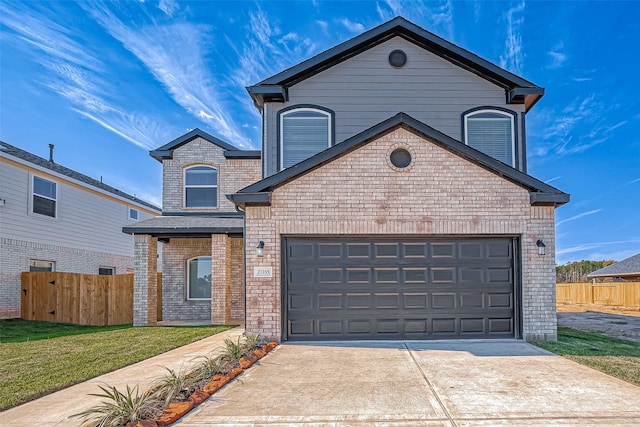traditional home with brick siding, fence, a garage, and concrete driveway